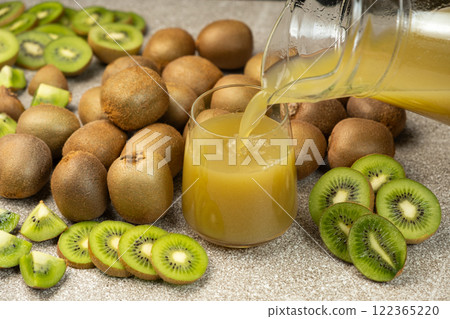 Kiwi juice pour into a glass from a jug Kiwi juice pour into a glass from a jug 122365220