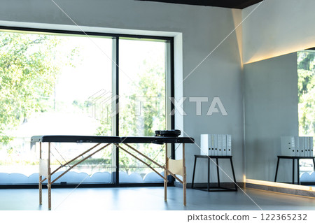Empty hospital physio room with wellness table for therapeutic activity Empty hospital physio room with wellness table for therapeutic activity 122365232