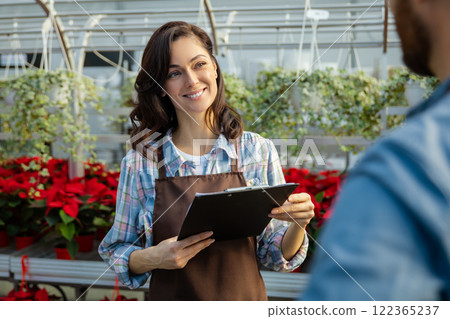 Two professionals talking in the greenhouse discussing plant cultivation 122365237