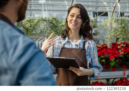 Two professionals talking in the greenhouse discussing plant cultivation 122365238