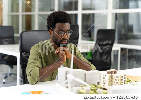 Young male architect looking at the new living area mock up and feeling contented 122365436