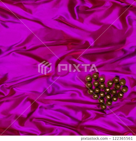 Seamless heart-shaped chocolate candy pattern on purple silk fabric background. 122365561