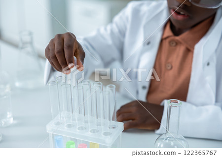 Female scientist holding tubes with liquid conducting experiment in chemistry 122365767