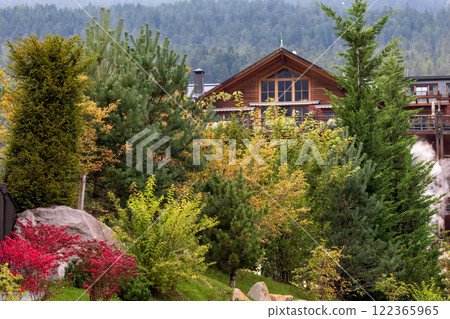 Ortisei, Italy houses and mountains in summer 122365965
