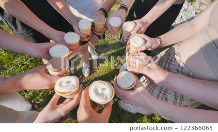 High school students forming a circle and enjoying ice cream cones together during a summer day 122366065