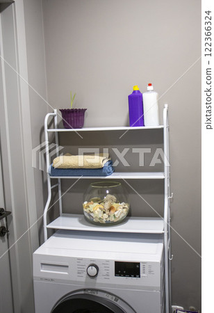 Shelf above the washing machine with household items Shelf above the washing machine with household items 122366324