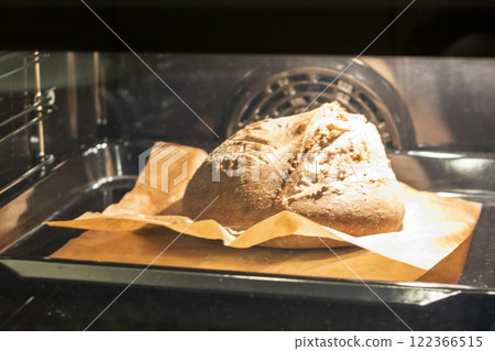 Shot of the freshly baked loaf of home made rye bread in the oven 122366515