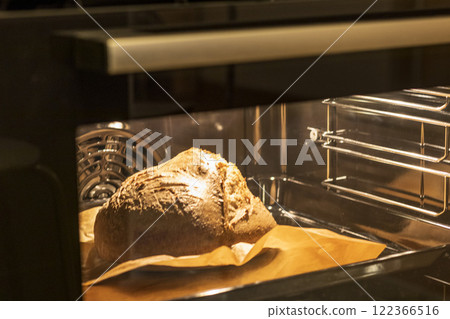 Shot of the freshly baked loaf of home made rye bread in the oven 122366516
