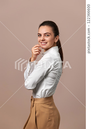 caucasian businesswoman lady with crossed arms in white shirt and beige pants caucasian businesswoman lady with crossed arms in white shirt and beige pants 122366600