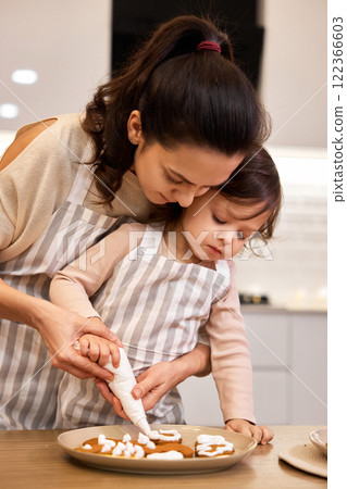 happy mother and little child girl bake cookies on the kitchen at home happy mother and little child girl bake cookies on the kitchen at home 122366603
