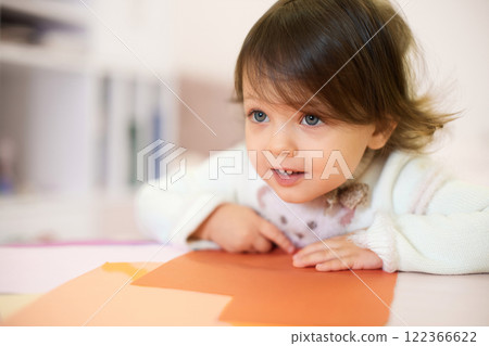 little child girl sitting at the table at home, child development. 122366622