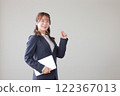 Business woman holding a tablet and holding a guts pose_1 122367013