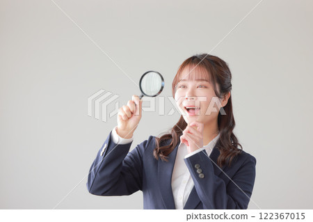 A businesswoman who discovered something through a magnifying glass_1 A businesswoman who discovered something through a magnifying glass_1 122367015