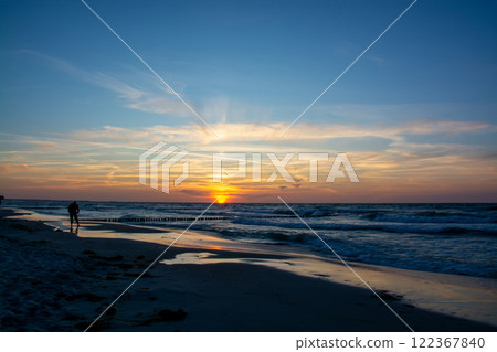 Photographer in the sunset at the beach of Zingst, Darss, Germany Photographer in the sunset at the beach of Zingst, Darss, Germany 122367840