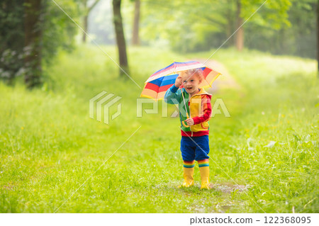 Child playing in the rain under umbrella 122368095
