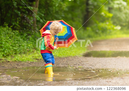 Child playing in the rain Child playing in the rain 122368096