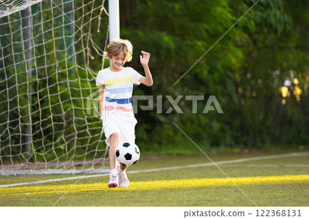 Child playing football. Kids play soccer. Child playing football. Kids play soccer. 122368131