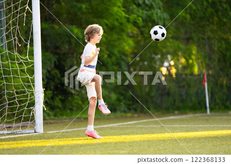 Child playing football. Kids play soccer. 122368133