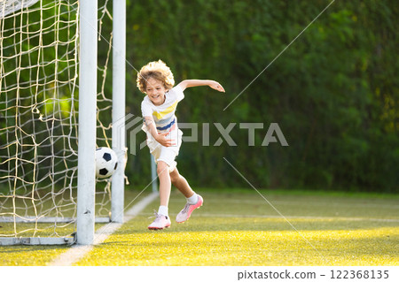 Child playing football. Kids play soccer. 122368135