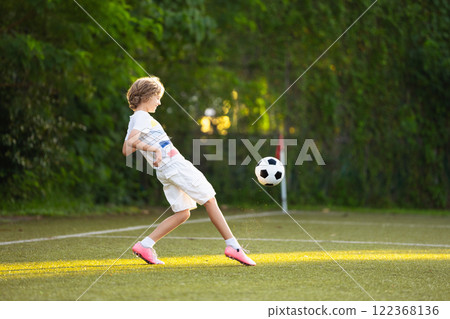 Child playing football. Kids play soccer. Child playing football. Kids play soccer. 122368136