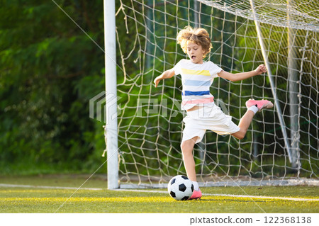 Child playing football. Kids play soccer. 122368138