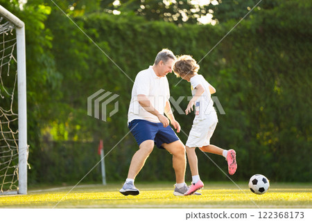 Child playing football. Kids play soccer. 122368173