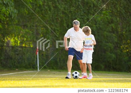 Child playing football. Kids play soccer. 122368174