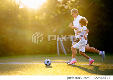 Child playing football. Kids play soccer. 122368175