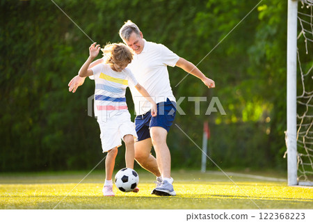 Child playing football. Kids play soccer. 122368223