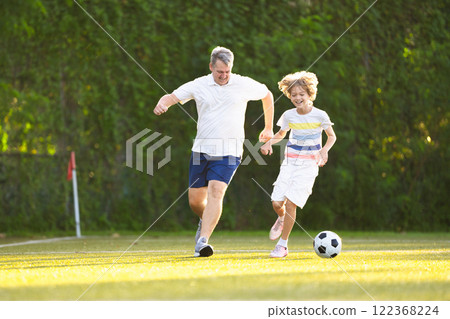 Child playing football. Kids play soccer. 122368224