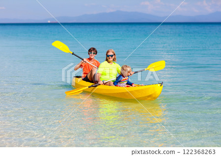 Kids kayaking in ocean. Family in kayak in tropical sea Kids kayaking in ocean. Family in kayak in tropical sea 122368263