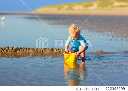 Kids playing on beach. Children play at sea. Kids playing on beach. Children play at sea. 122368299
