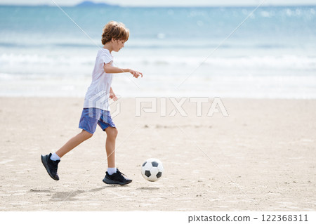 Child playing football. Kids play soccer. 122368311
