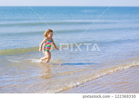 Kids playing on beach. Children play at sea. 122368330