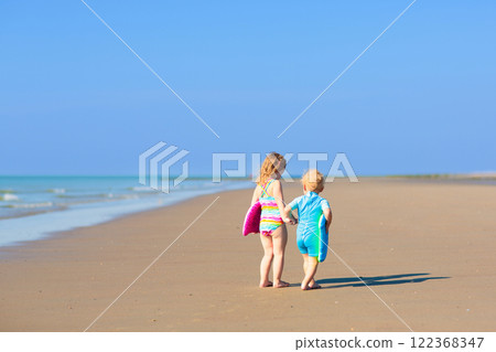 Kids playing on beach. Children play at sea. 122368347