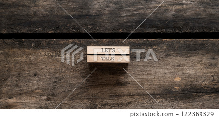 Lets talk sign written on two wooden pegs Lets talk sign written on two wooden pegs 122369329