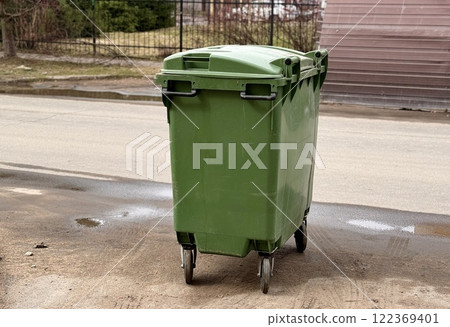 Green garbage can is used for waste containment and garbage collection located in special place for food waste 122369401