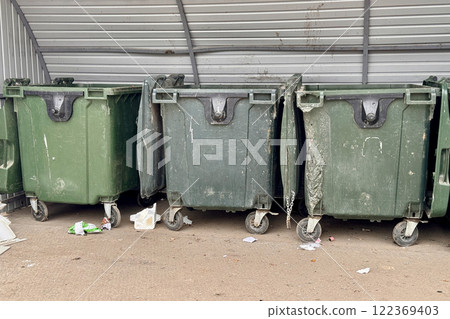 Row of green garbage cans are used for waste containment and garbage collection located in special place for food waste Row of green garbage cans are used for waste containment and garbage collection located in special place for food waste 122369403