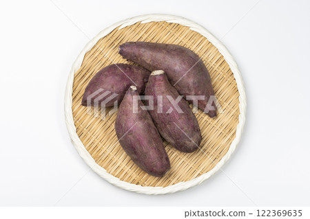 Aerial view of sweet potatoes served on a bamboo basket on a white background Aerial view of sweet potatoes served on a bamboo basket on a white background 122369635