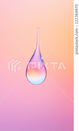 Clear drop of liquid hanging with a pointed top, reflecting a vibrant orange and pink gradient on its smooth surface against a matching background 122369970