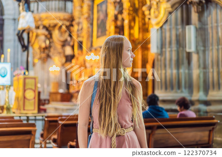 Female tourist exploring the Metropolitan Cathedral in Mexico City. Woman admiring the architecture and history of Mexico's iconic landmark. Concept of cultural heritage, religious tourism, and travel 122370734