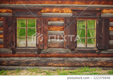 Open shutters revealing windows in charming log cabin, showcasing traditional russian architecture and craftsmanship Open shutters revealing windows in charming log cabin, showcasing traditional russian architecture and craftsmanship 122370846
