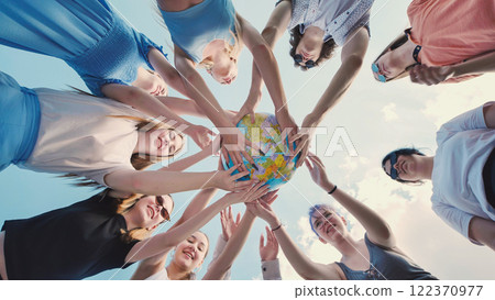 School friends come together to raise awareness for global citizenship and environmental sustainability by holding a globe 122370977