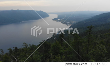 Lake Baikal in the evening. Yenisei river meandering through rugged siberian mountains, revealing pristine wilderness and serene natural expanse 122371300