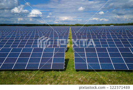 Aerial view of big sustainable electric power plant with many rows of solar photovoltaic panels for producing clean electrical energy. Renewable electricity with zero emission concept 122371489
