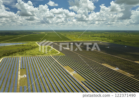 Aerial view of big sustainable electric power plant with many rows of solar photovoltaic panels for producing clean electrical energy. Renewable electricity with zero emission concept 122371490
