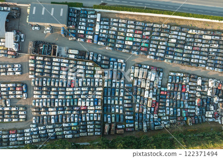 Aerial view of big parking lot of junkyard with rows of discarded broken cars. Recycling of old vehicles 122371494