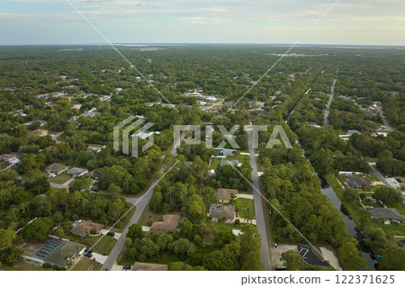 Aerial landscape view of suburban private houses between green palm trees in Florida rural area 122371625
