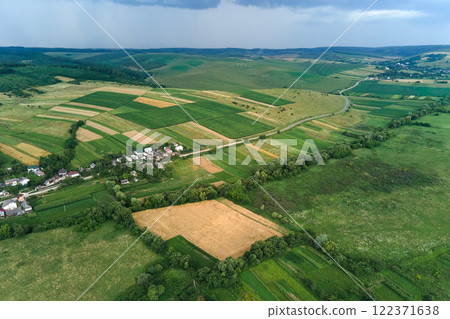 Aerial landscape view of green cultivated agricultural fields with growing crops on bright summer day 122371638