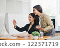 Two colleagues engaged in business analytics, using digital tablets over financial charts. Colleagues Collaborating with Tablets on Business Analytics. 122371719